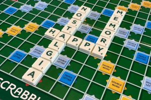 A Scrabble board showing the words 'nostalgia', 'happy' and 'memory'.